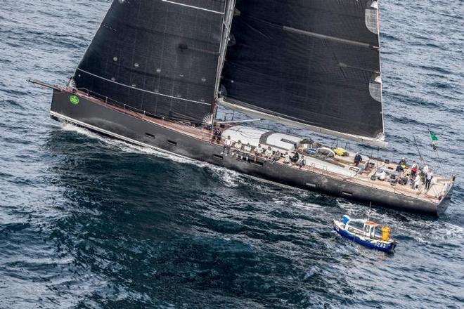 At 115ft, Nikata the largest boat in the Rolex Fastnet Race passes a very small fishing boat en route back from the Rock ©  Rolex/ Kurt Arrigo http://www.regattanews.com